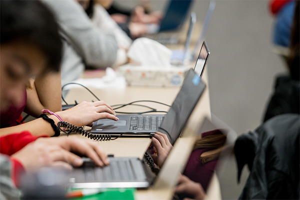 Curriculum and instruction students in a lecture hall using laptops