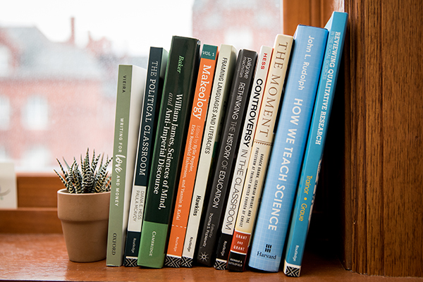lineup of education books on a shelf