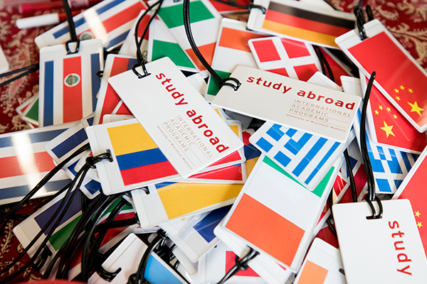 Pile of luggage tags showing flags from different countries